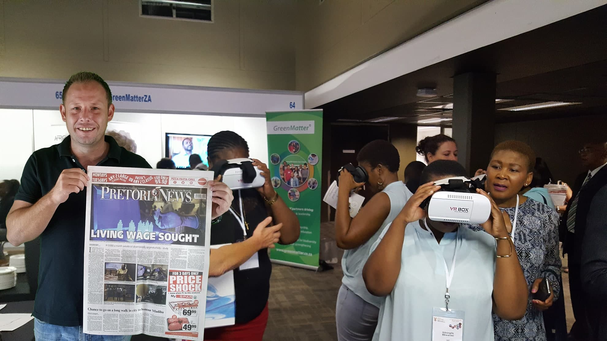 Mr. Rudi Snyders holding up the Pretoria Newspaper with NWU front-page article